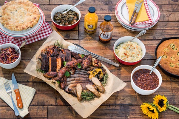 BBQ Picnic Table Setting with barbecue sauces meats and side dishes