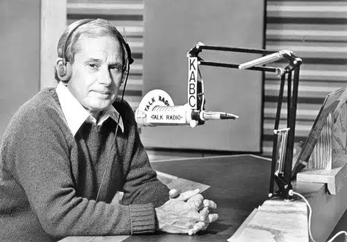 Elmer Dills Black and white vintage broadcasting into a KABC microphone
